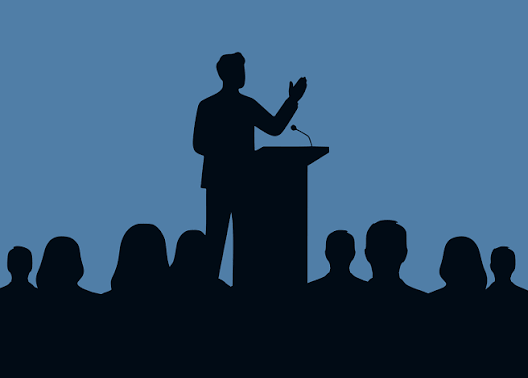 Speaker Kam Hashin explaining in front of an audience. Source: https://hashimpr.com/about-us/speaking-engagements/